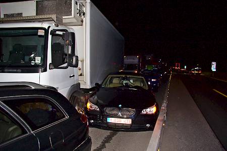 Der BMW ist zwischen LKW und Mittelleitplanke eingeklemmt